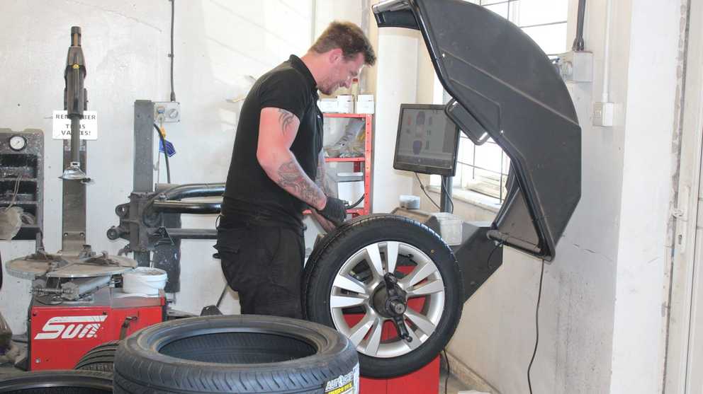Mechanic working on a tyre in the garage