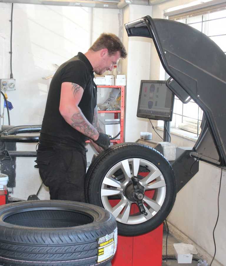 Mechanic working on a tyre in the garage