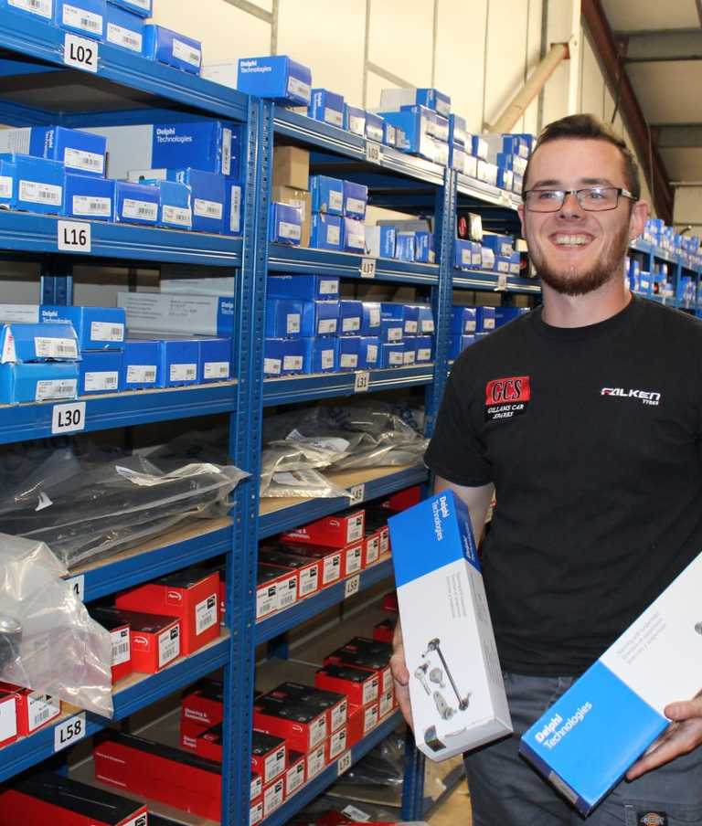 Shop member holding a product in each hand